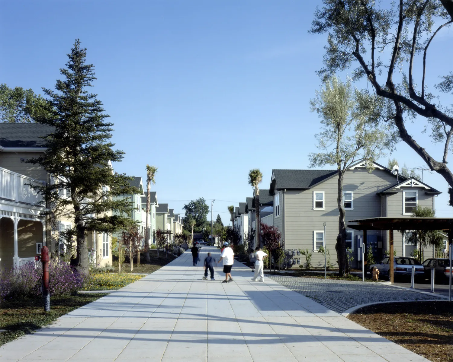 People walking down the pedestrian path at Oroysom Village in Fremont, California.