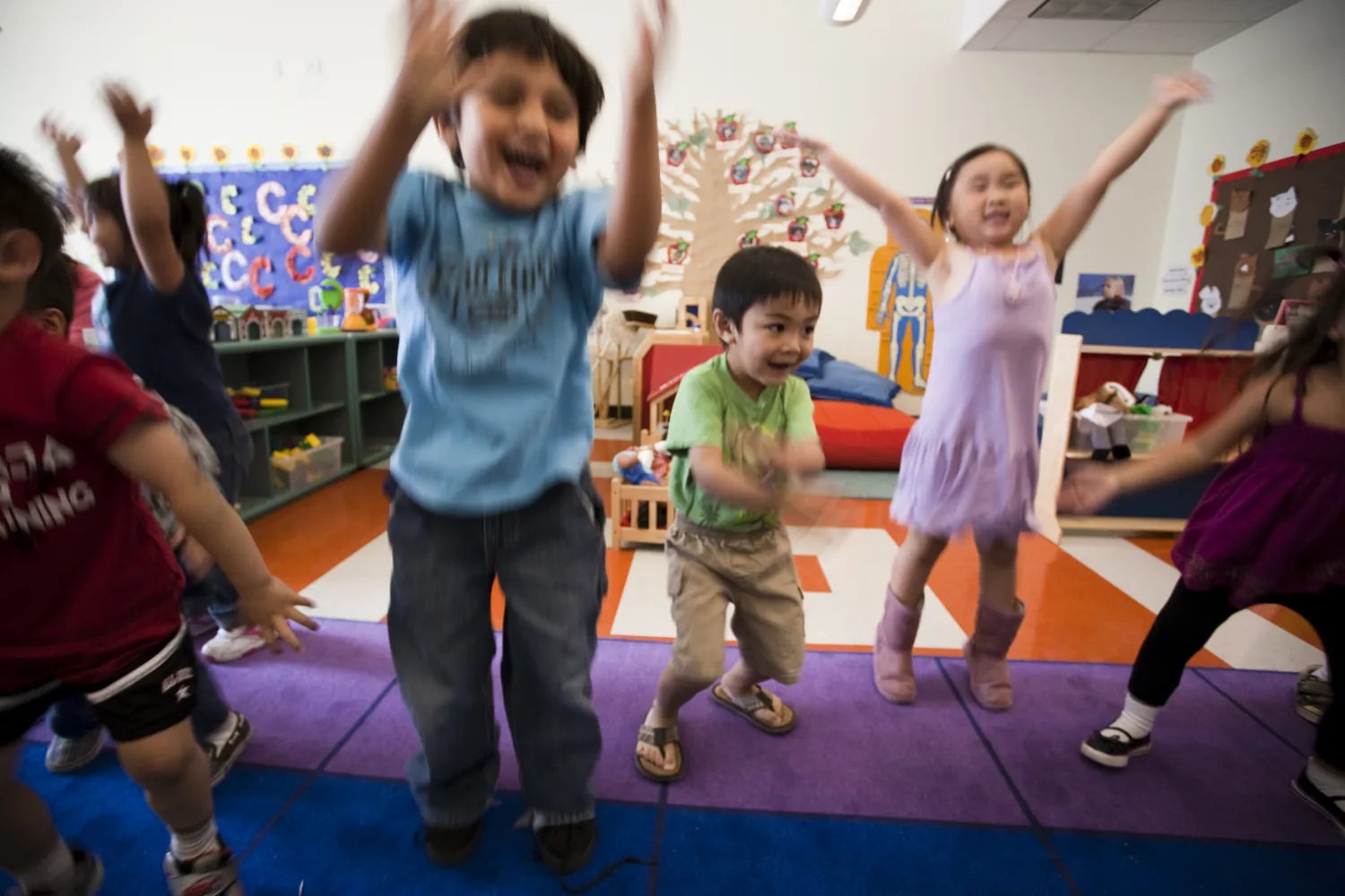 Children jumping in the classroom at Paseo Senter in San Jose, California.