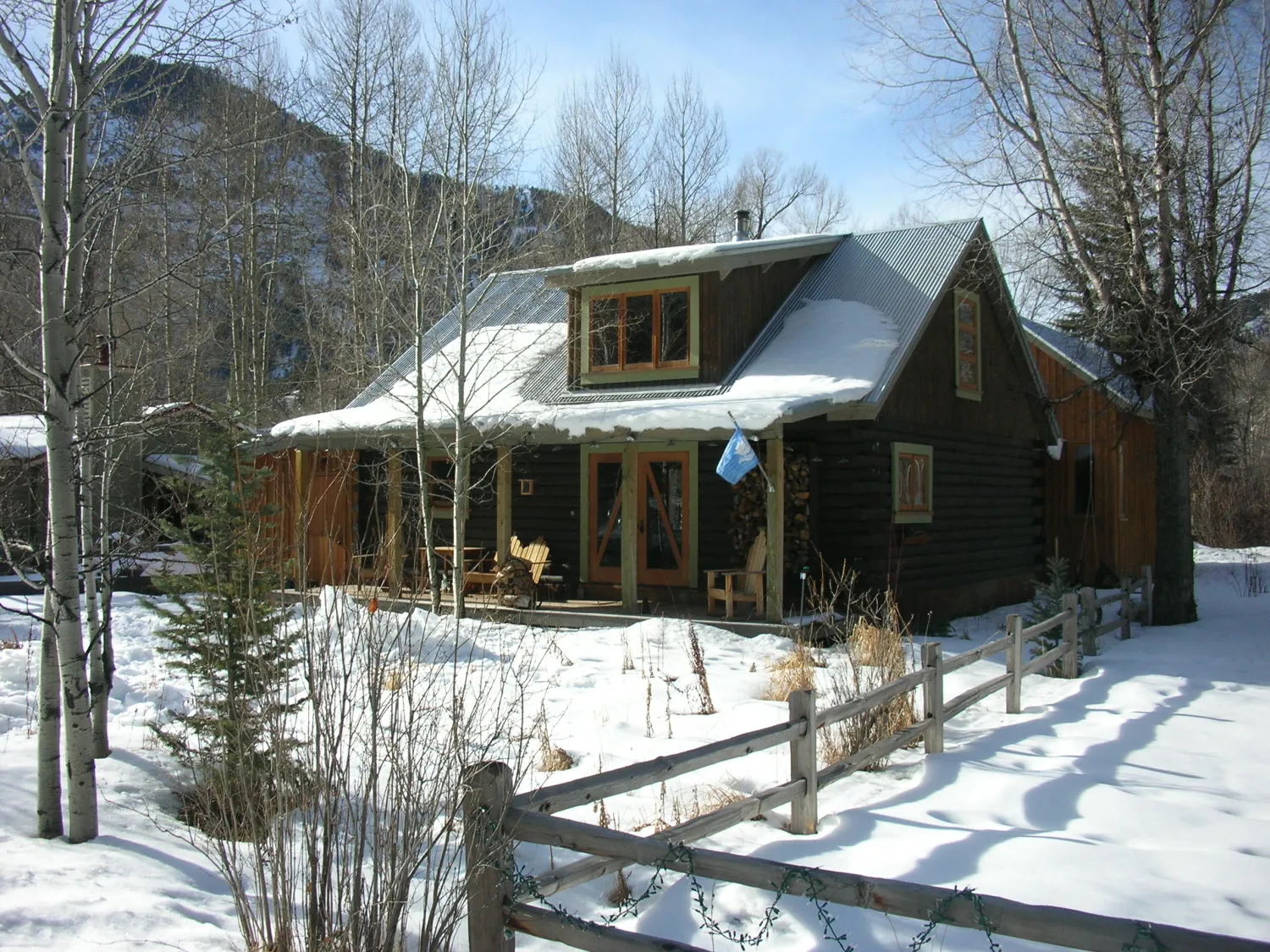 Exterior view of the Redstone Cabin covered in snow in Redstone Colorado.