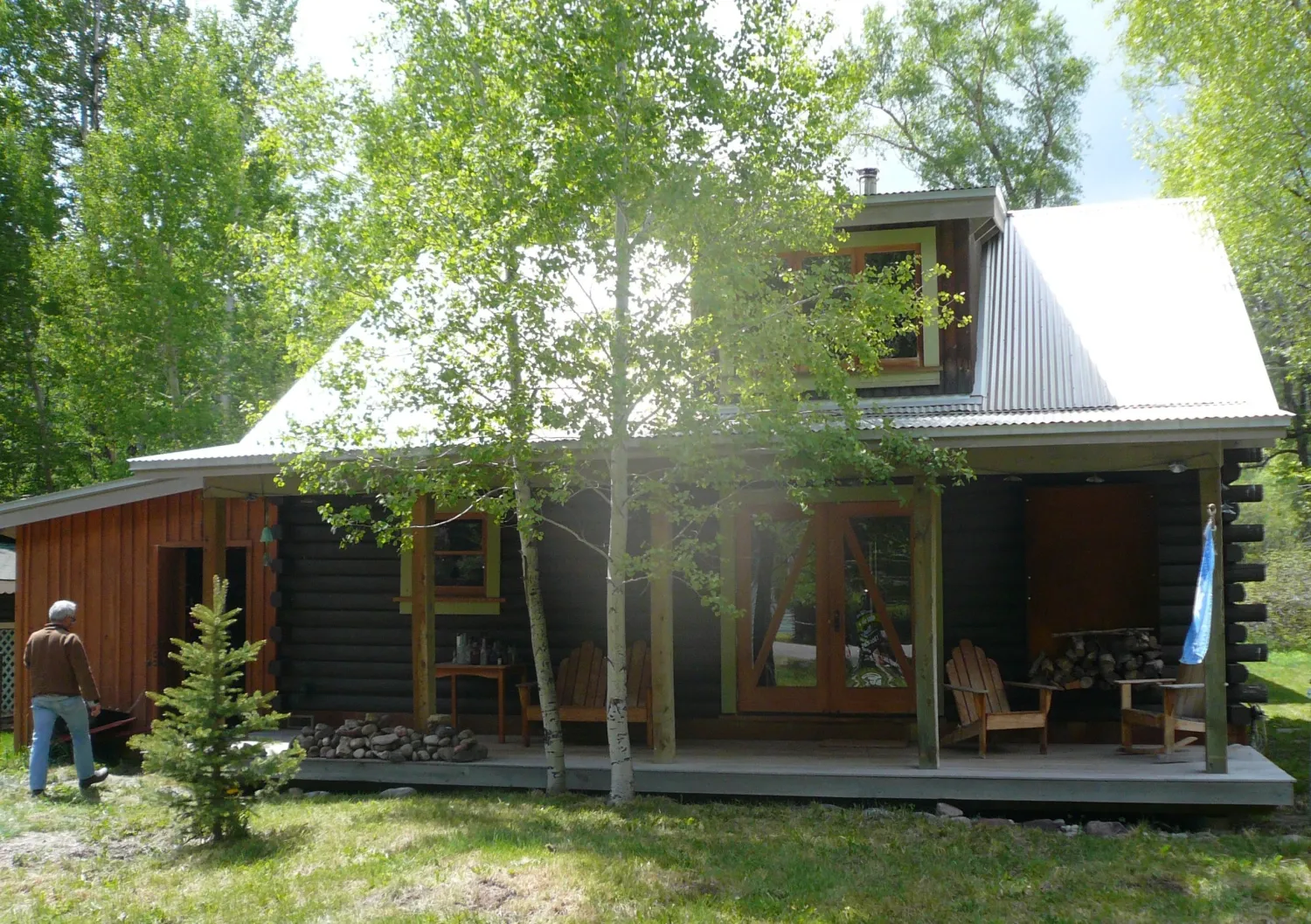 Exterior view of Redstone Cabin in spring surrounded in green in Redstone Colorado.