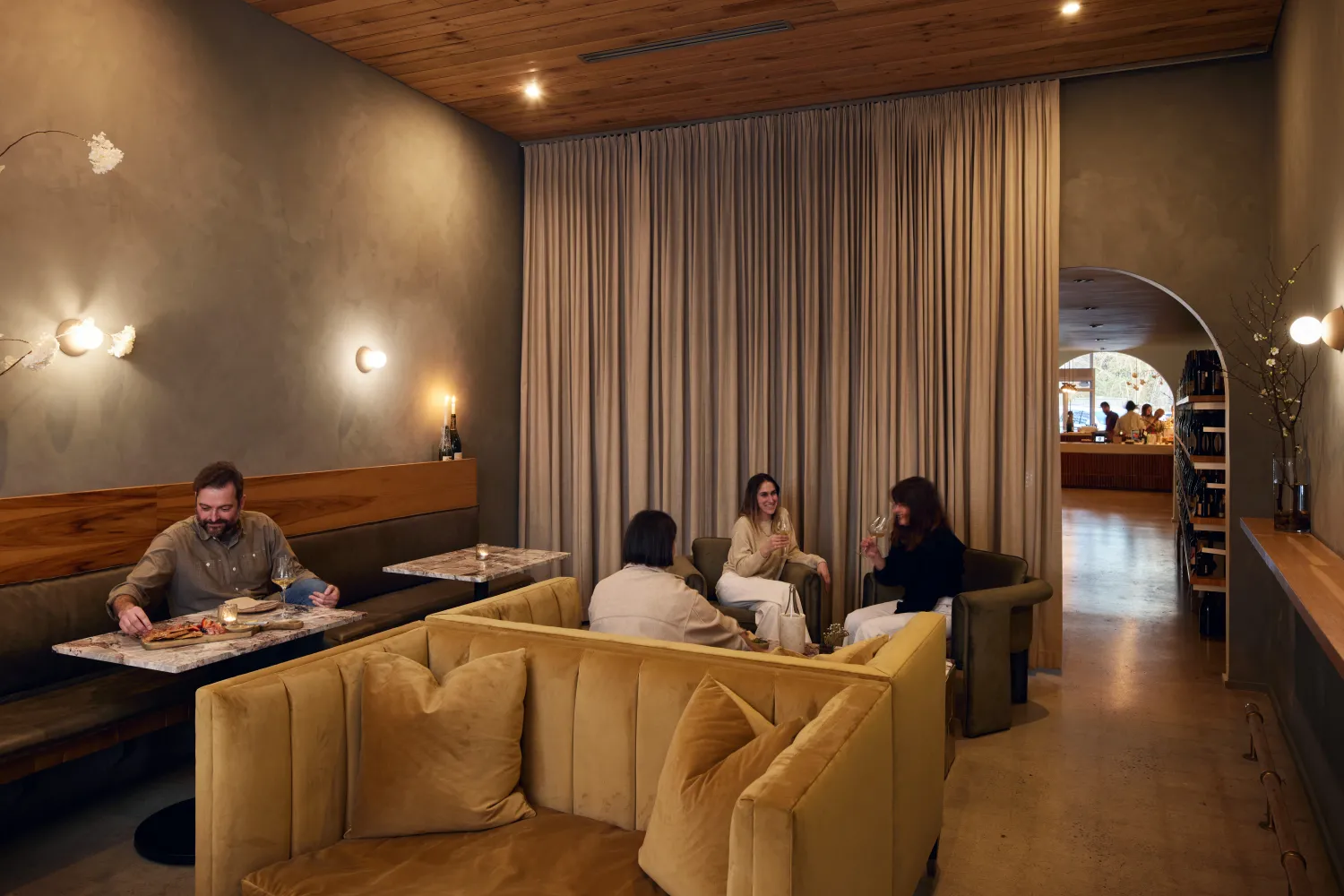 People sitting in the Champagne Room inside Golden Age Wine in Birmingham, Alabama.