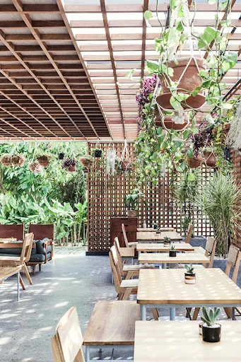 Interior of the open air restaurant at The Slow hotel in Canggu, Bali.