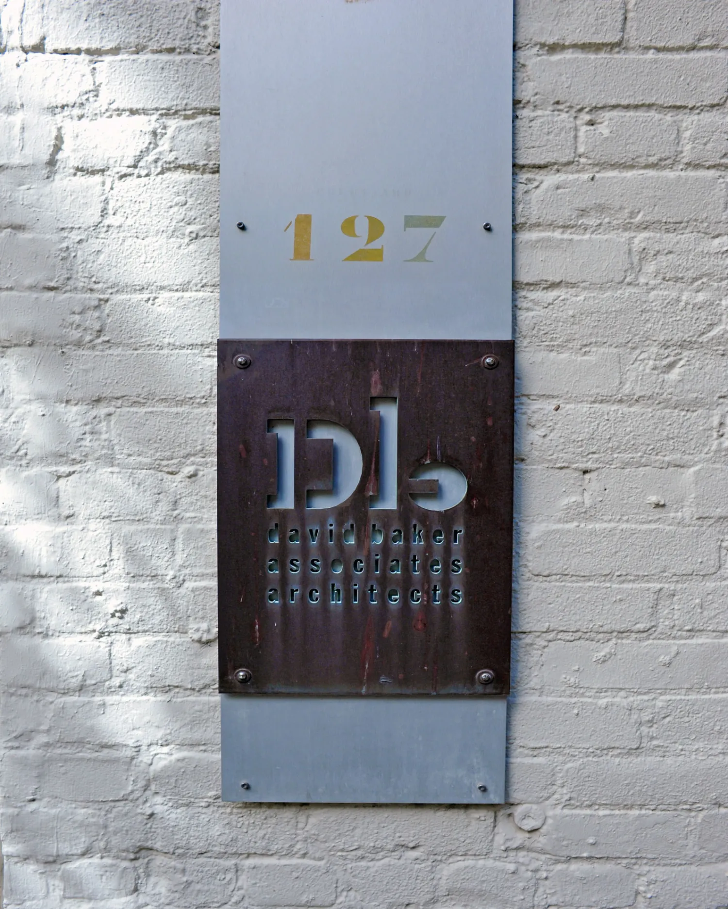 DBA Copper water-jet-cut sign outside of the David Baker Architects Office in San Francisco.