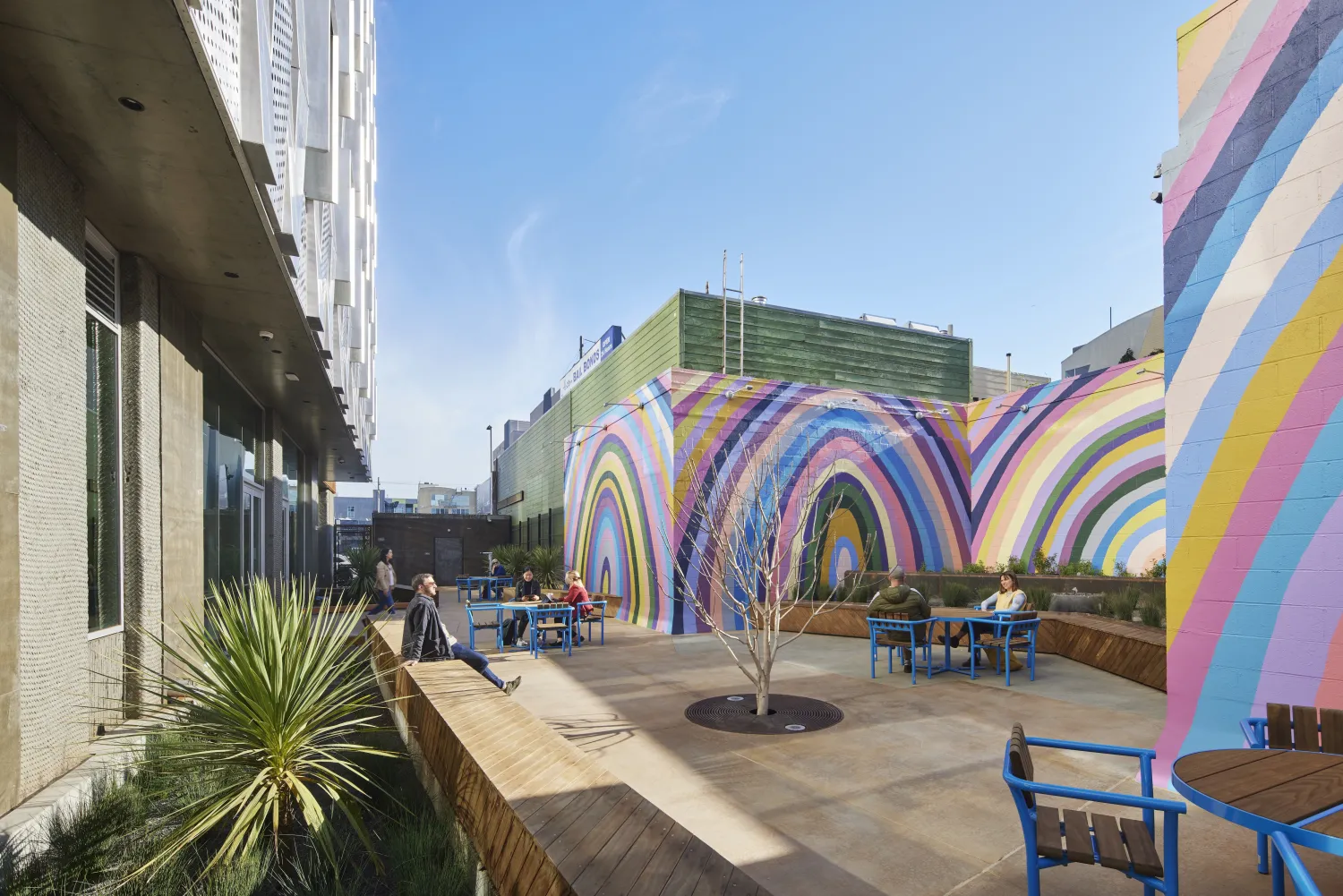Outdoor residential courtyard with rainbow at Tahanan Supportive Housing in San Francisco.