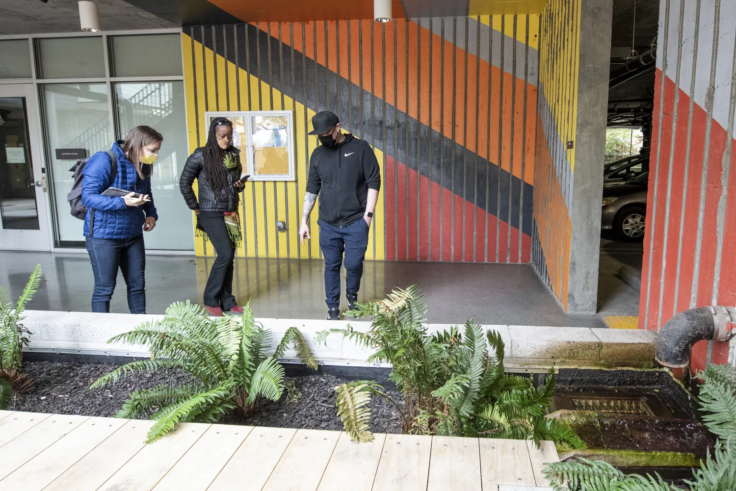 Principal Katie Ackerly and two others standing in the courtyard of Edwina Benner Plaza.