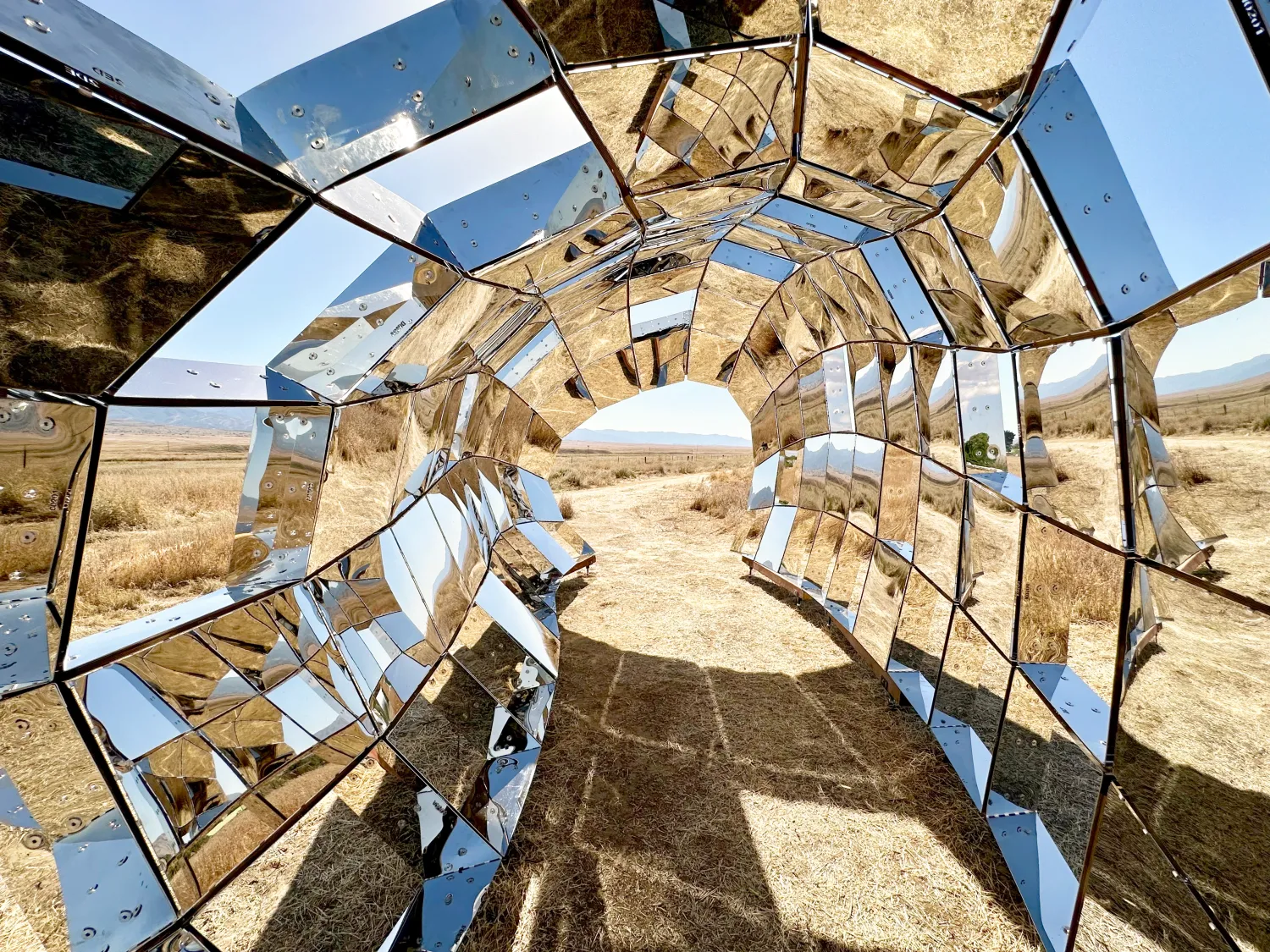 Looking through peepSHOW in the desert with mountains behind it in New Cuyama, California.