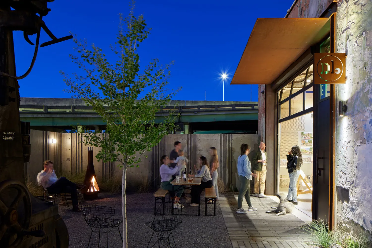 The Bandsaw Building courtyard at night with the DBA_BHM office doors open in Birmingham, Alabama.