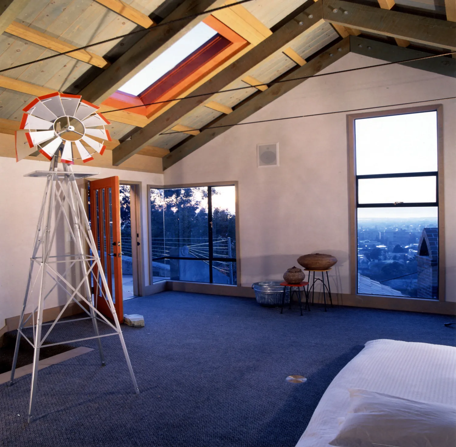 Main bedroom with door leading to the side door inside Revenge of the Stuccoids in Berkeley, California.