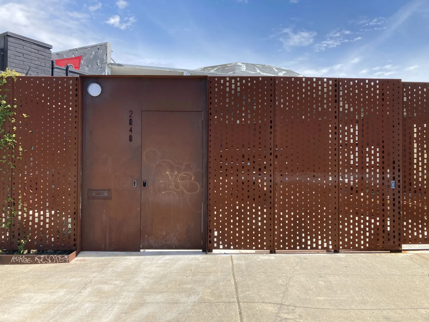 Cor-ten steel fence enclosing the courtyard at David Baker Architects Office in Oakland, California.