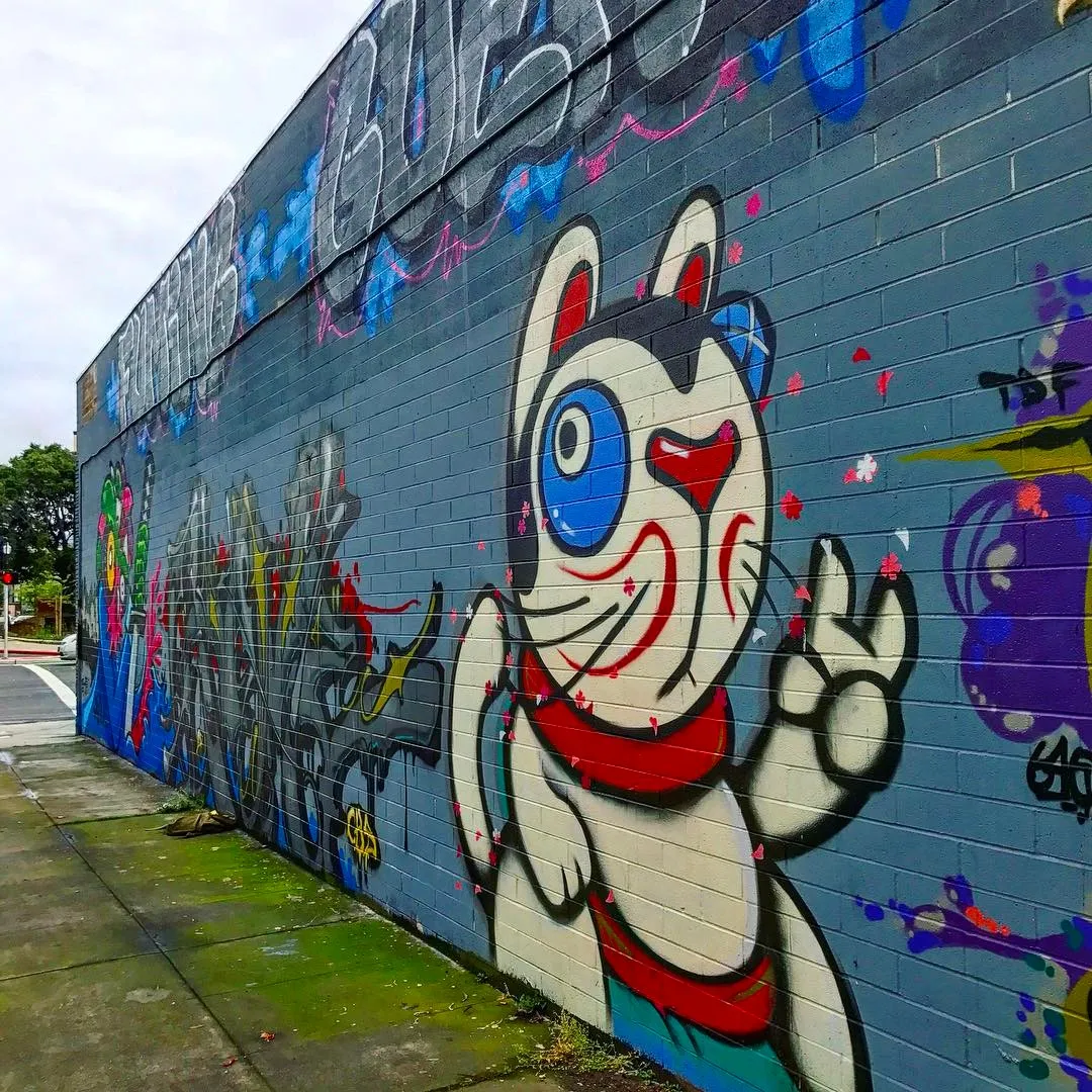 Detail of street art of a Japanese lucky cat on David Baker Architects office in Oakland.