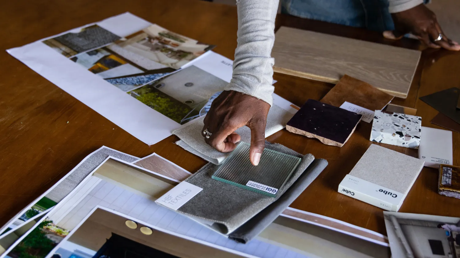 Woman's hand looking at different interior materials