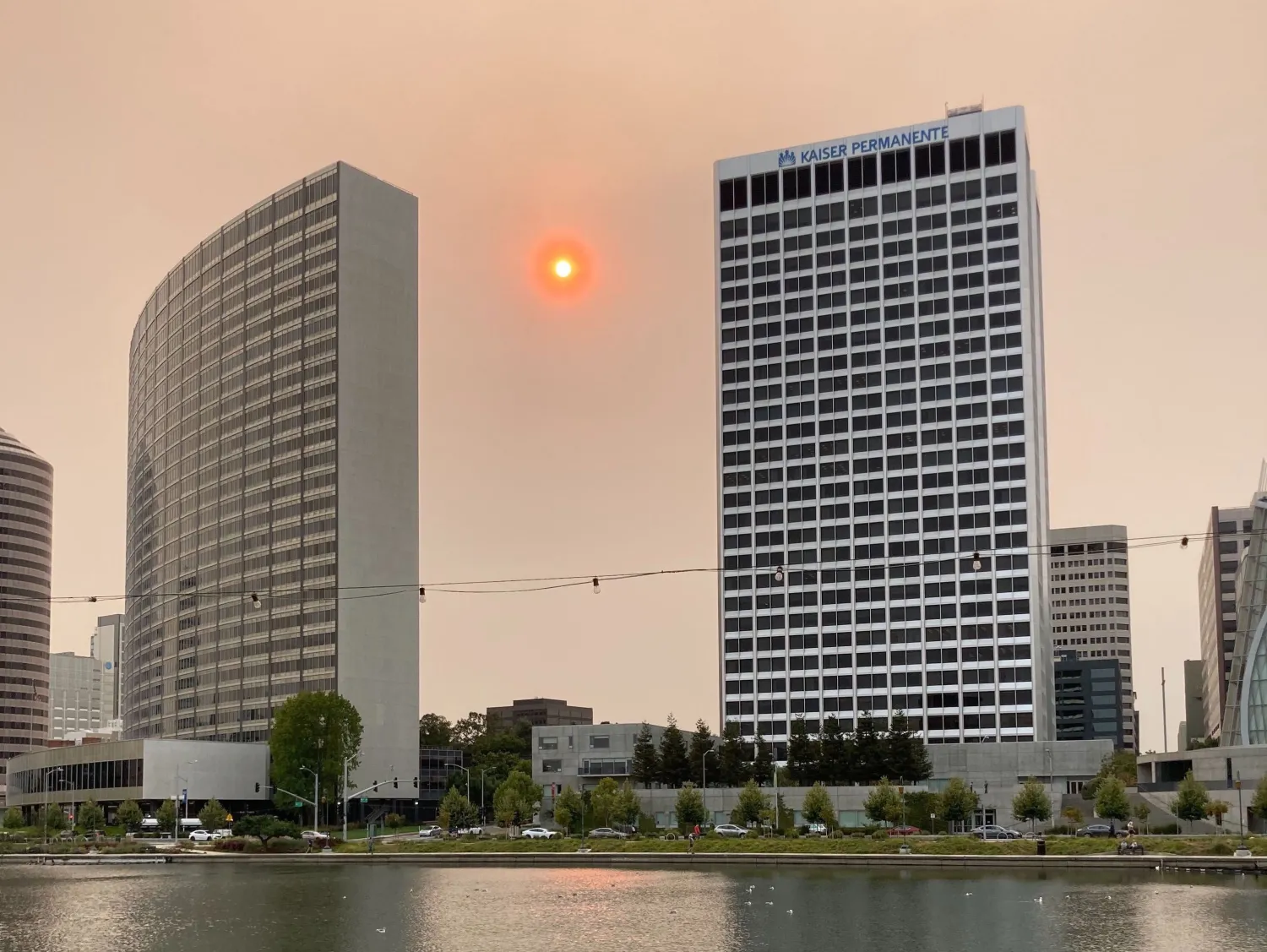 Orange haze in the sky at Lake Merit in Oakland after fires.