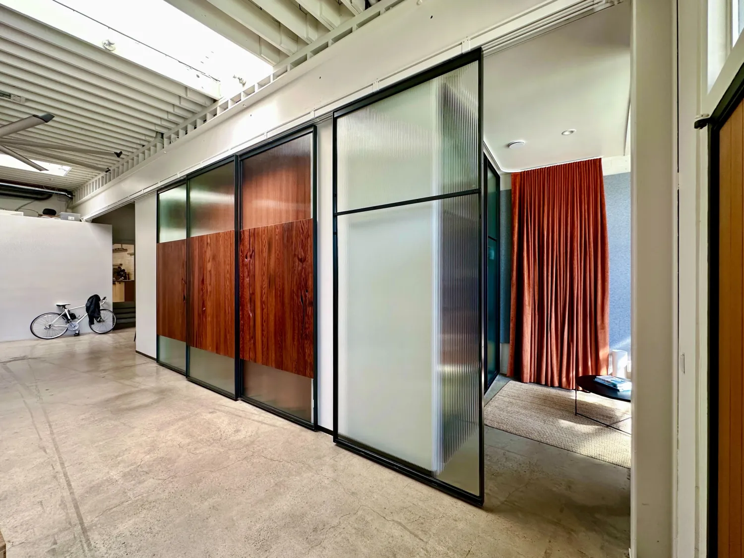 DBA_OAK sliding doors separating the conference room and storefront.