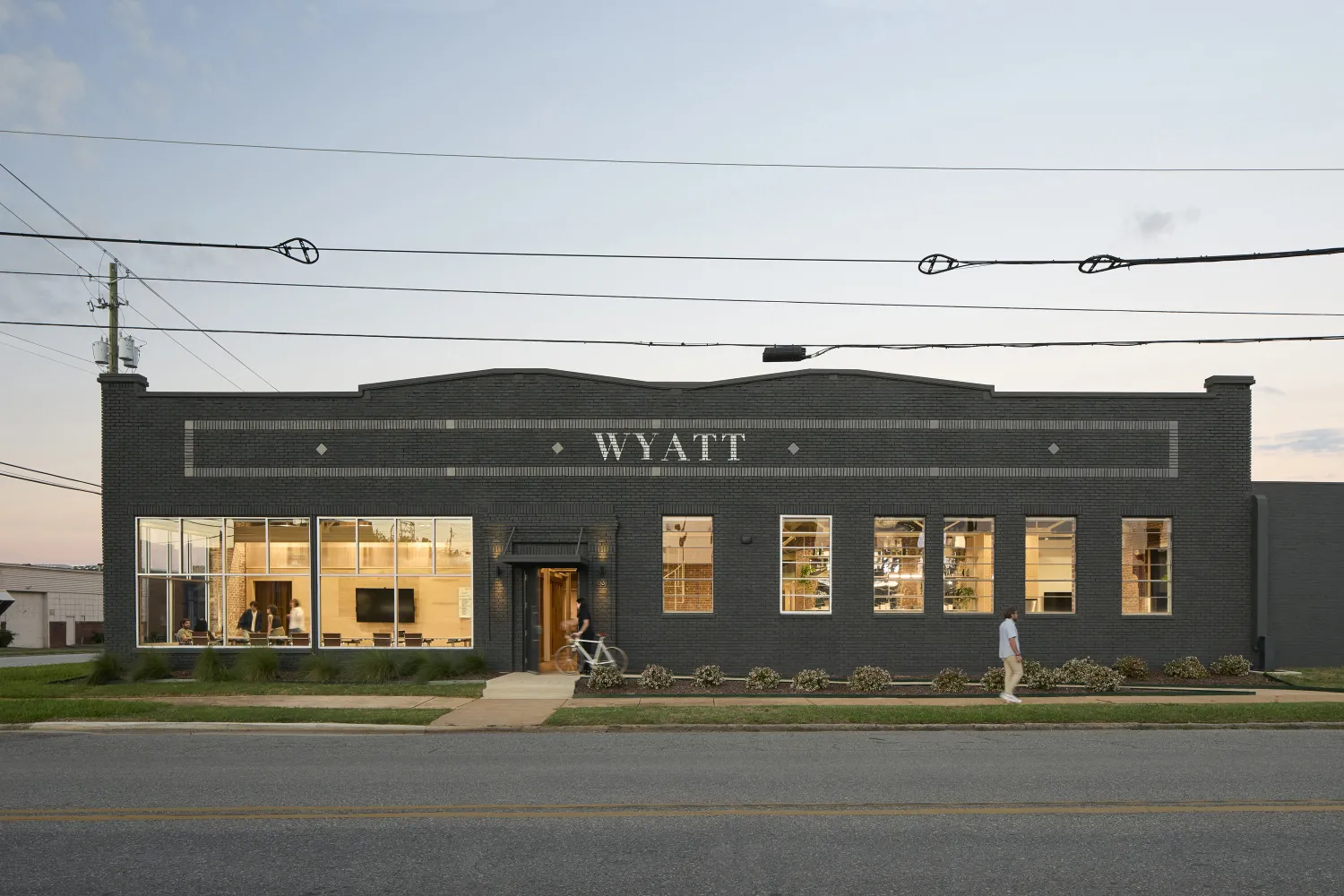 Exterior street view of Wyatt Builds at dusk.