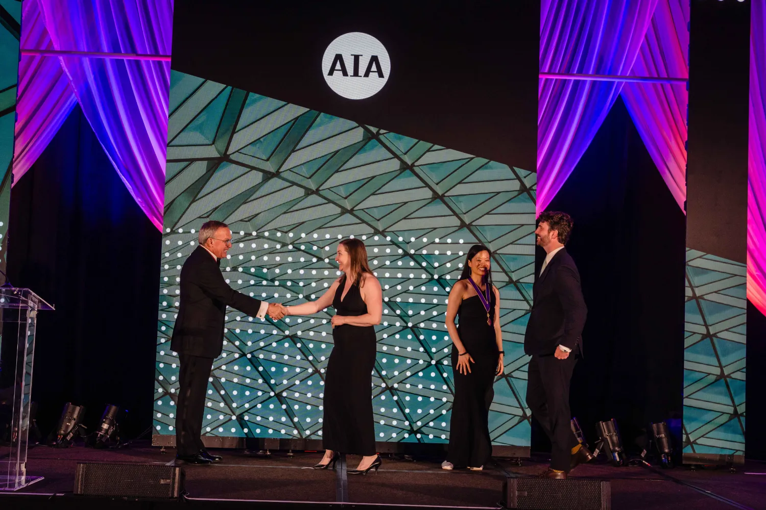 Two people accepting an award.
