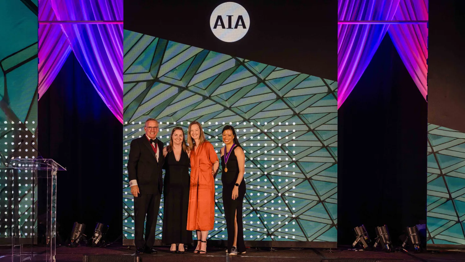 four people posing at the AIA conference.