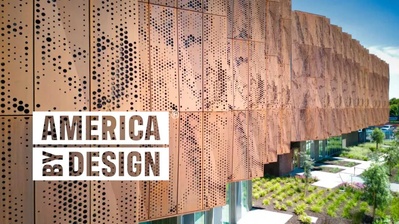 Detail of a multifamily building clad in weathered steel, with an overlaid logo reading "America By Design"