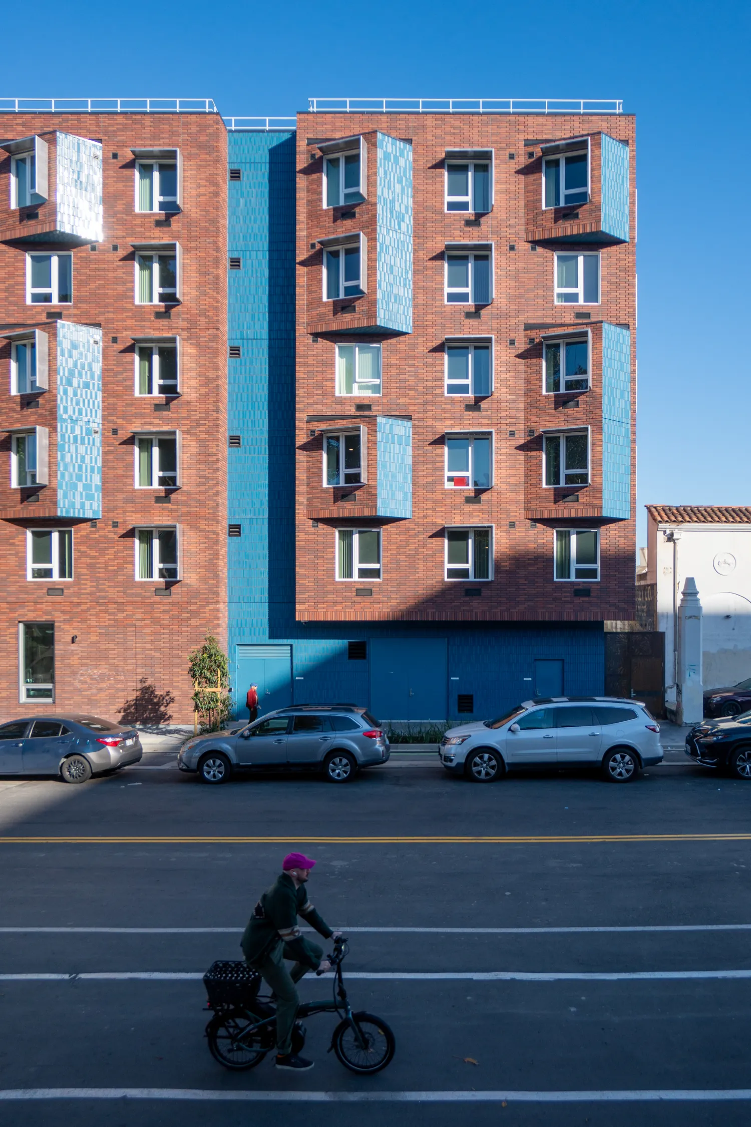 Shot of exterior facade of red brick building with blue brick accents
