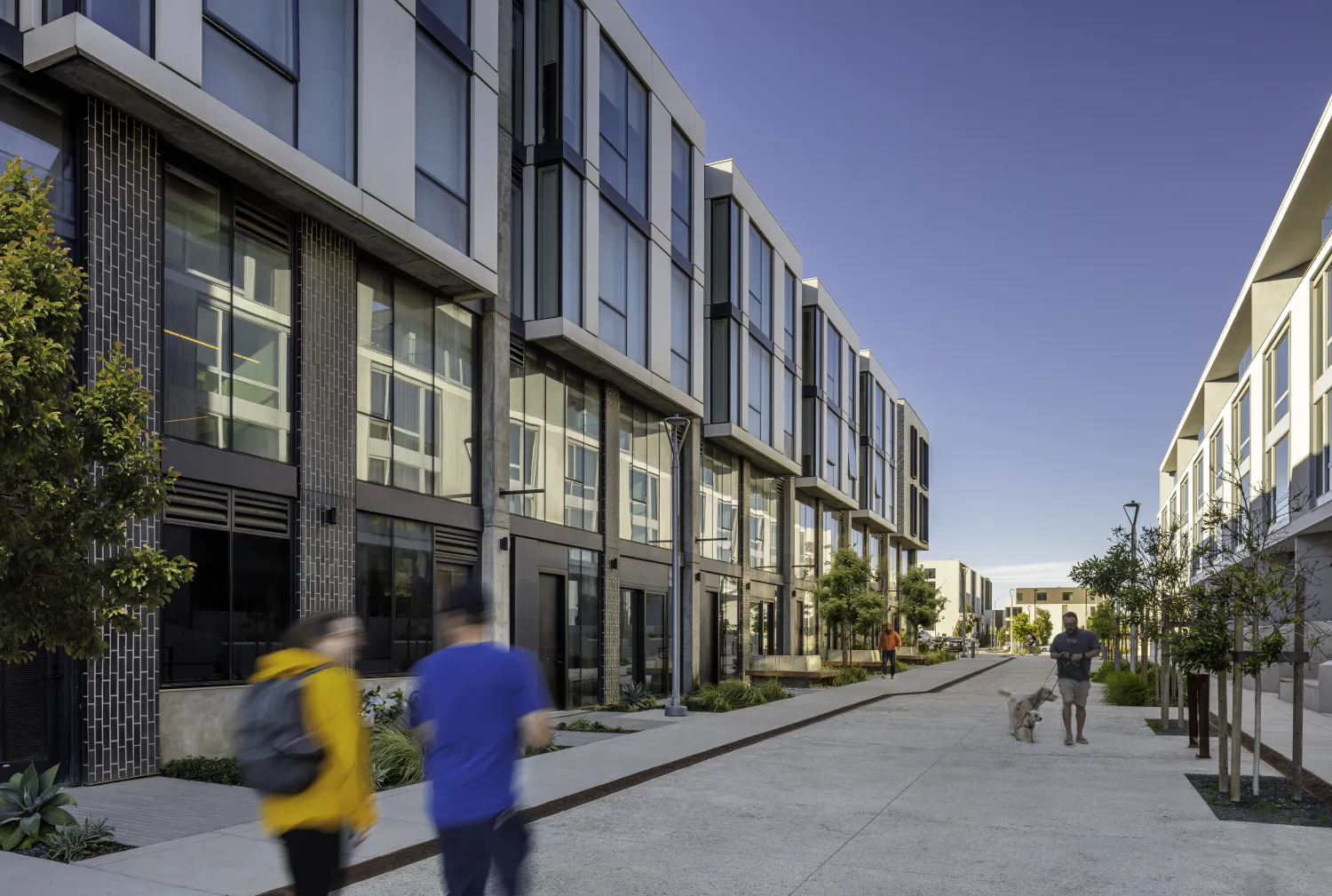 A pair of building podiums create a passageway, show with pedestrians