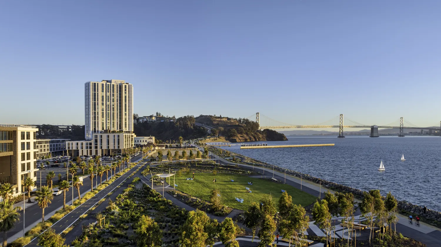 View of apartment building, park, Bay, and bridge