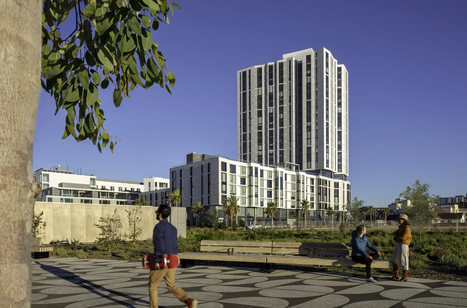 Apartment building with park and pathway and pedestrians