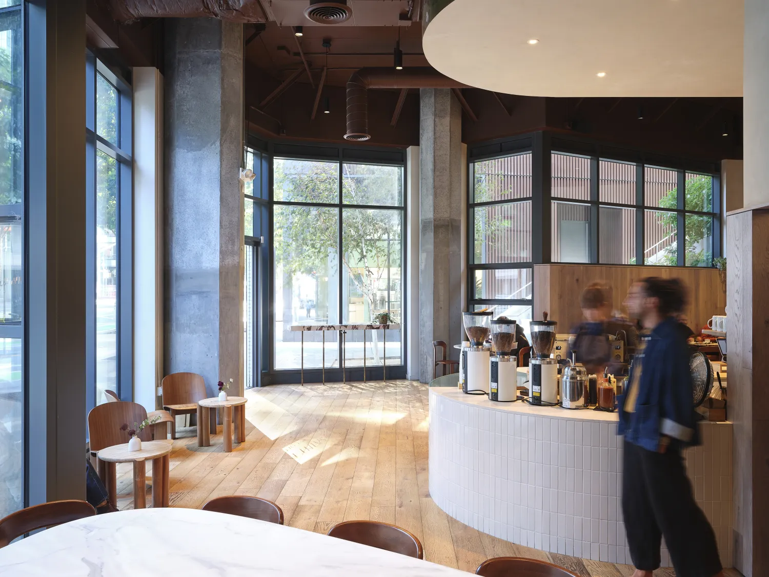 Overall interior shows order station and seating plys floor to ceiling windows