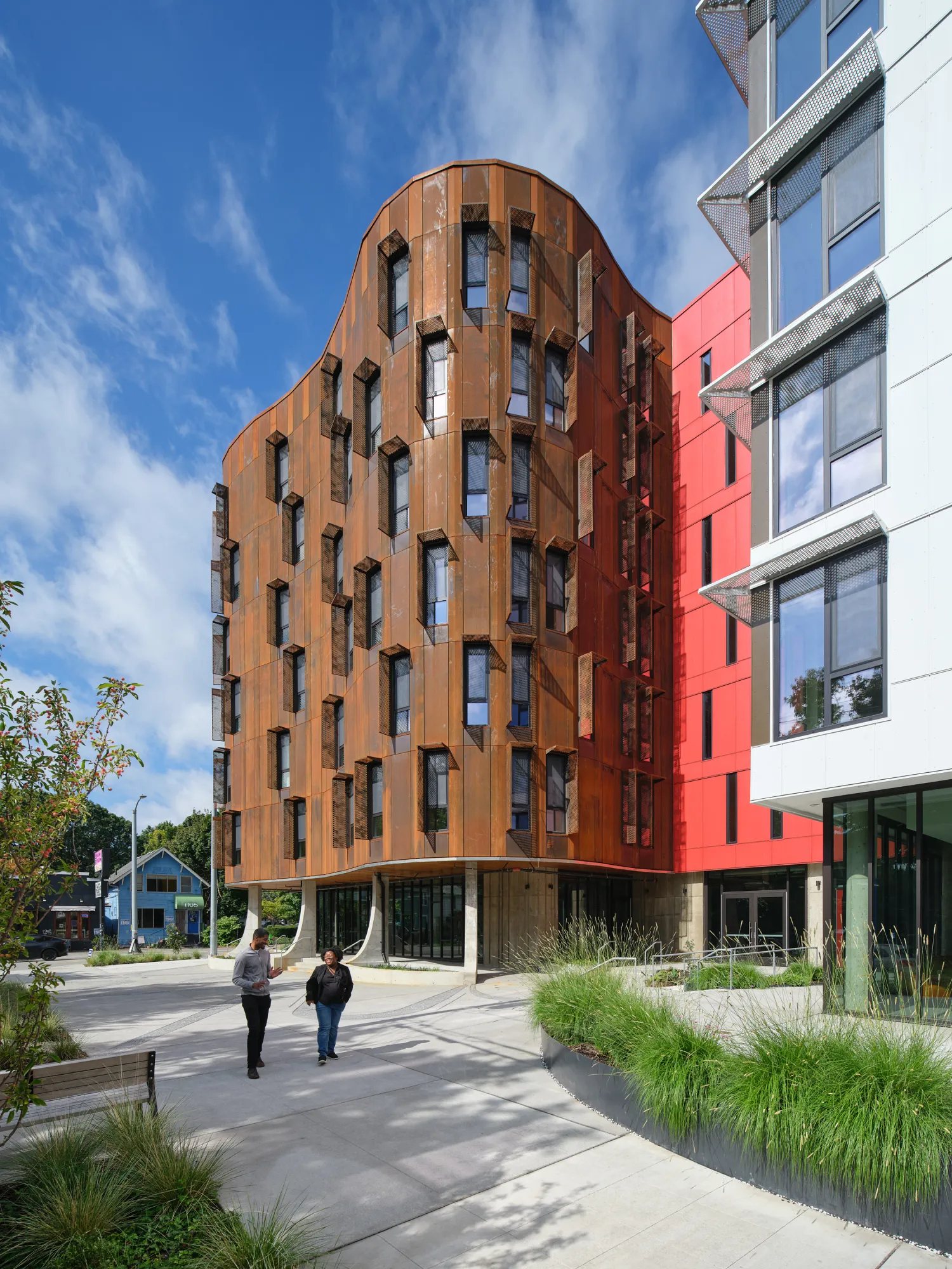 View of curved rust-colored facade of apartment building