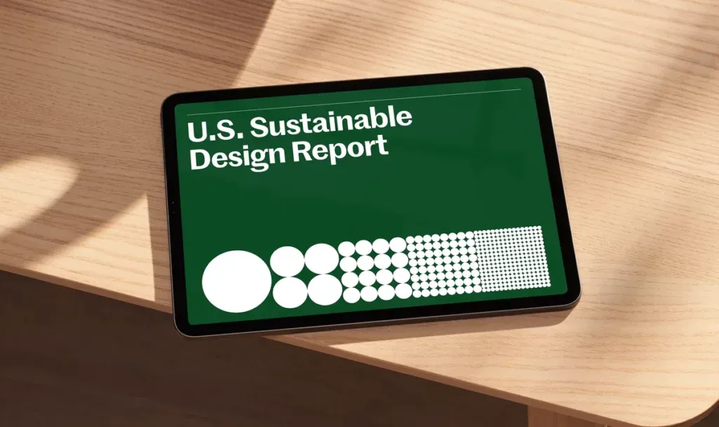 tablet with Sustainable Design Report header lying on a wood table