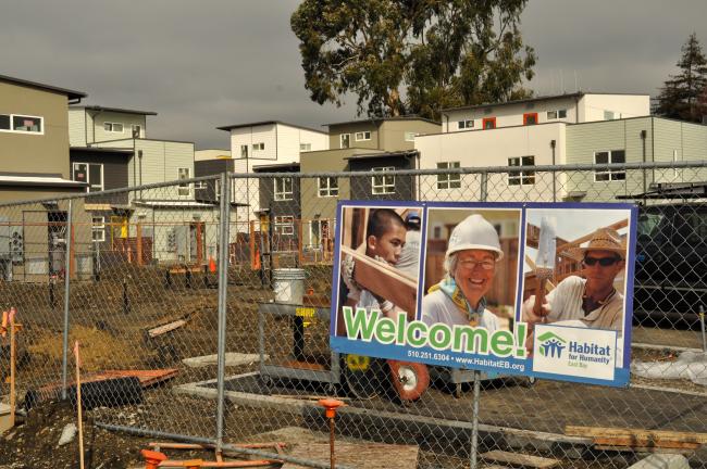 Construction site and signage for Kinsell Commons, on-site Habitat for Humanity townhouses at Tassafaronga Village in East Oakland, CA. 