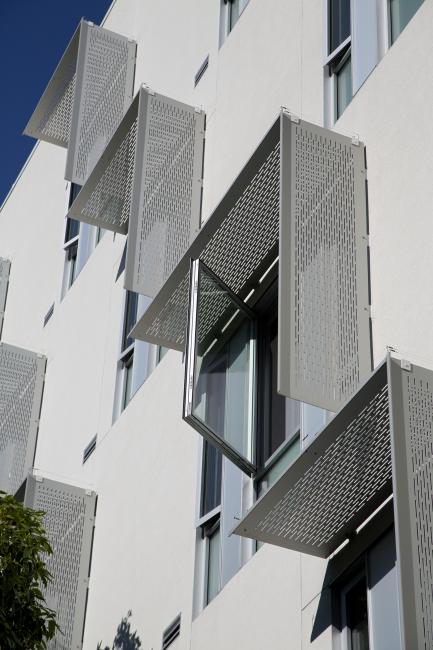 Detail of aluminum sunshades on a white wall at Richardson Apartments
