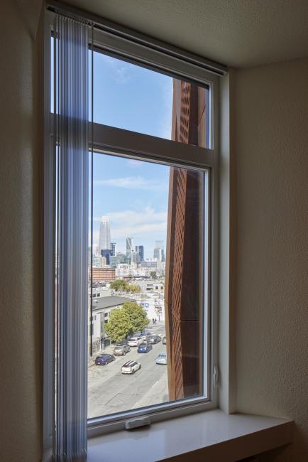 Looking out of a residents window at Tahanan Supportive Housing in San Francisco.