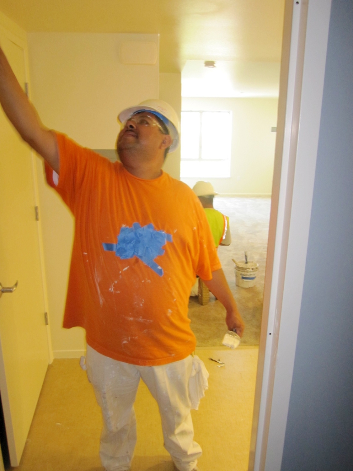 Man painting a unit at Armstrong Place Senior in San Francisco.