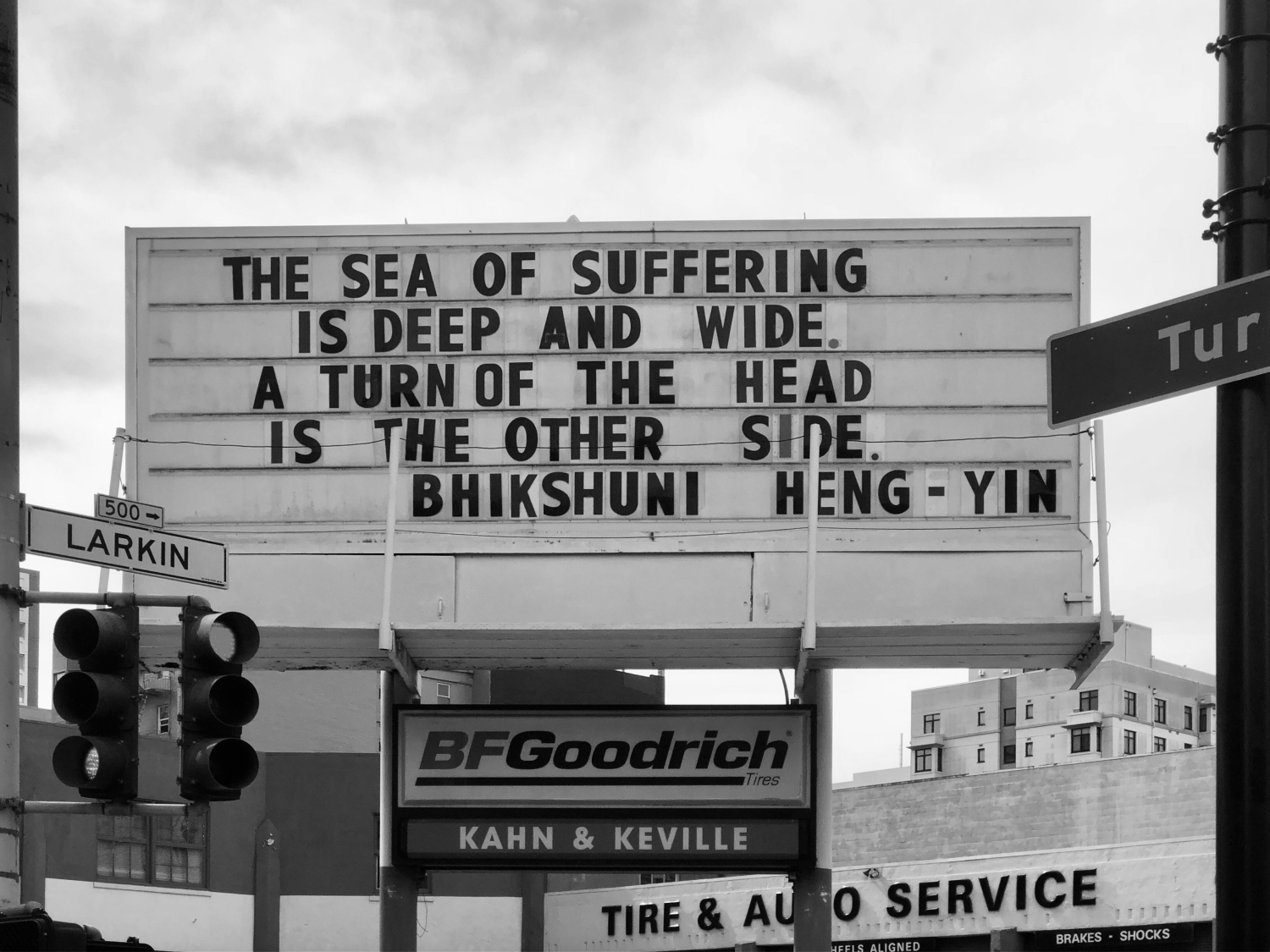 Sign at previous 555 Larkin location that states "The Sea of suffering is deep and wide. A turn of the head is the other side. - Bhikshuni Heng-Yin"