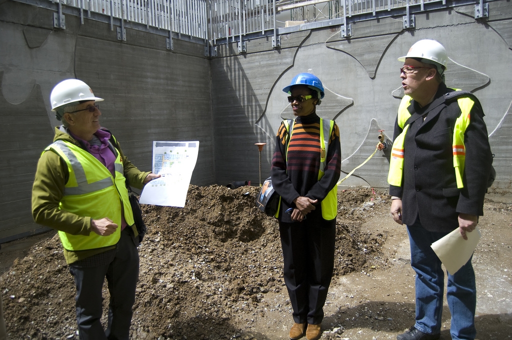 3 people with hard hats at the construction site of Armstrong Place Senior in San Francisco.