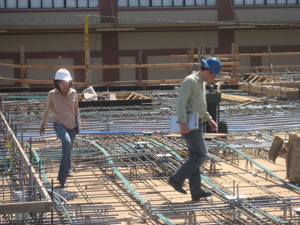 Man and woman wearing hard hats at the construction site at Armstrong Place Senior in San Francisco.