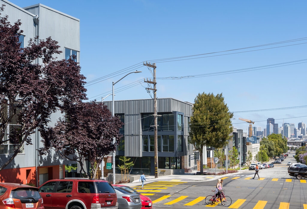 View across crosswalk with 18th and Arkansas Lofts in the foreground and Mason on Mariposa in the background, with the San Francisco skyline in the distance.