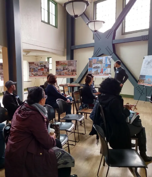 Community members sitting down at a meeting for 34th and San Pablo Affordable Family Housing in Oakland, California.