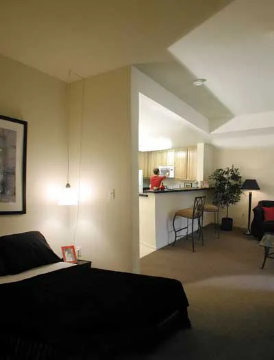 A studio unit view of the kitchen from the bedroom area at Lenzen Square in San Jose, California.