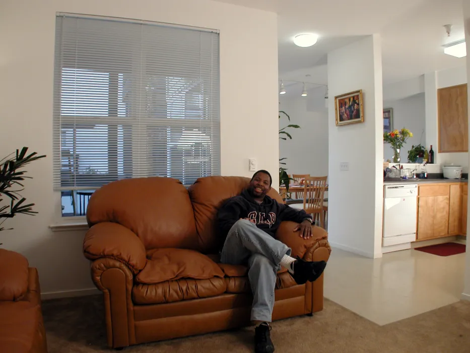 Resident sitting on his couch at his home in Linden Court in Oakland, California.