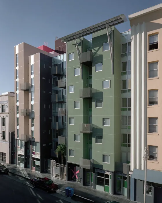 Curran House, an 8-story building in the Tenderloin, on a blue-sky day.