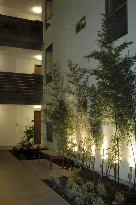 Courtyard at night at Folsom-Dore Supportive Apartments in San Francisco, California.