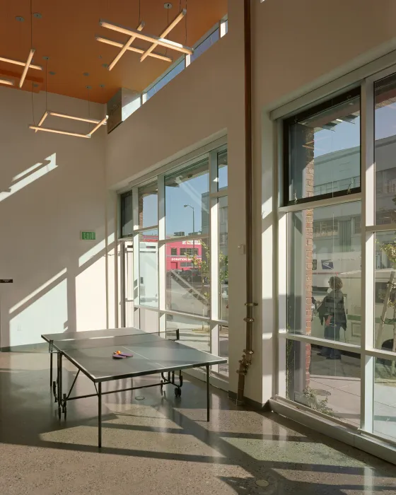 Flex space in the common area with a ping pong table at Folsom-Dore Supportive Apartments in San Francisco, California.