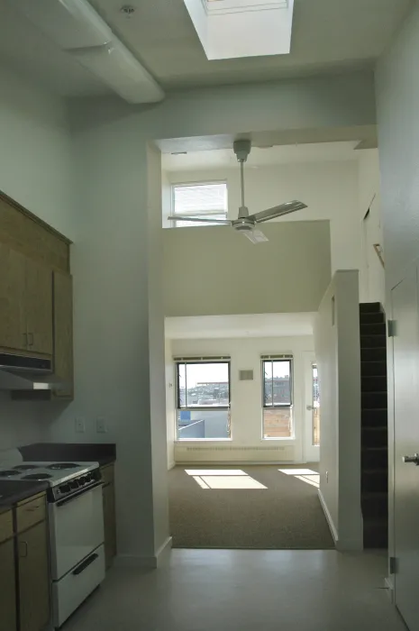 Kitchen and living area inside a unit at Folsom-Dore Supportive Apartments in San Francisco, California.