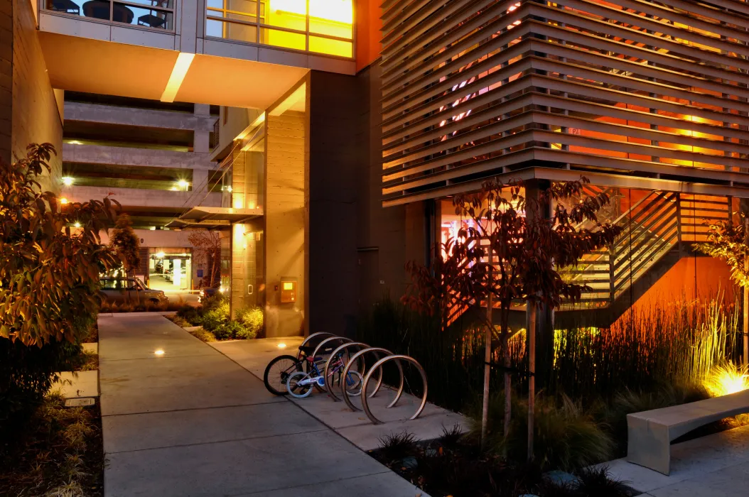 Bike parking next to stairs at 888 Seventh Street in San Francisco at night.