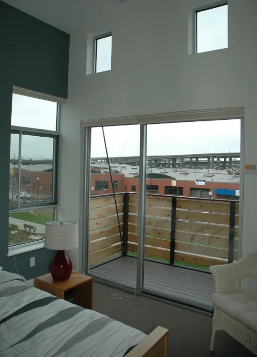 Bedroom and private balcony inside a townhome at West End Commons in Oakland, Ca.