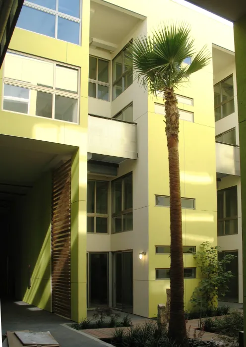 View of the two-story yellow resident building at Pacific Cannery Lofts in Oakland, California.