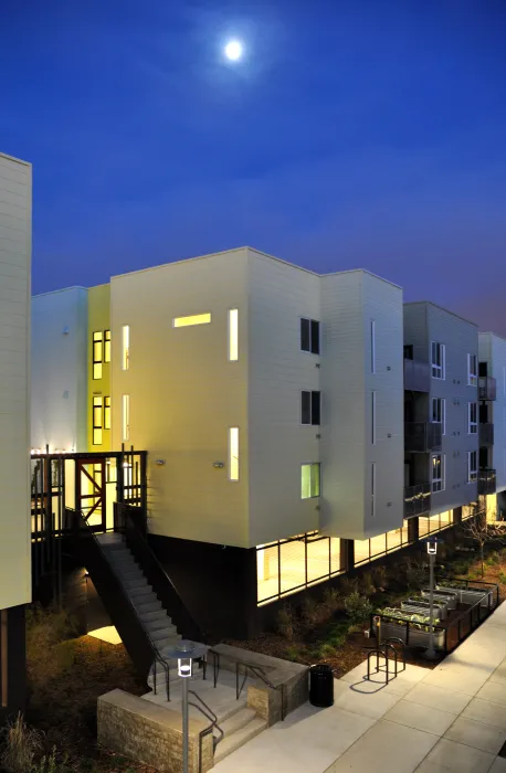 Exterior view at dusk of the pedestrian mews at Ironhorse at Central Station in Oakland, California.