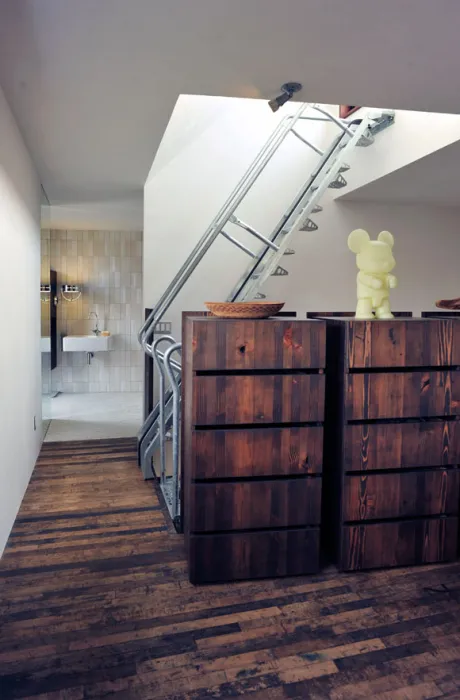 Interior view of sleeping loft area with the bathroom in the background on the third level.