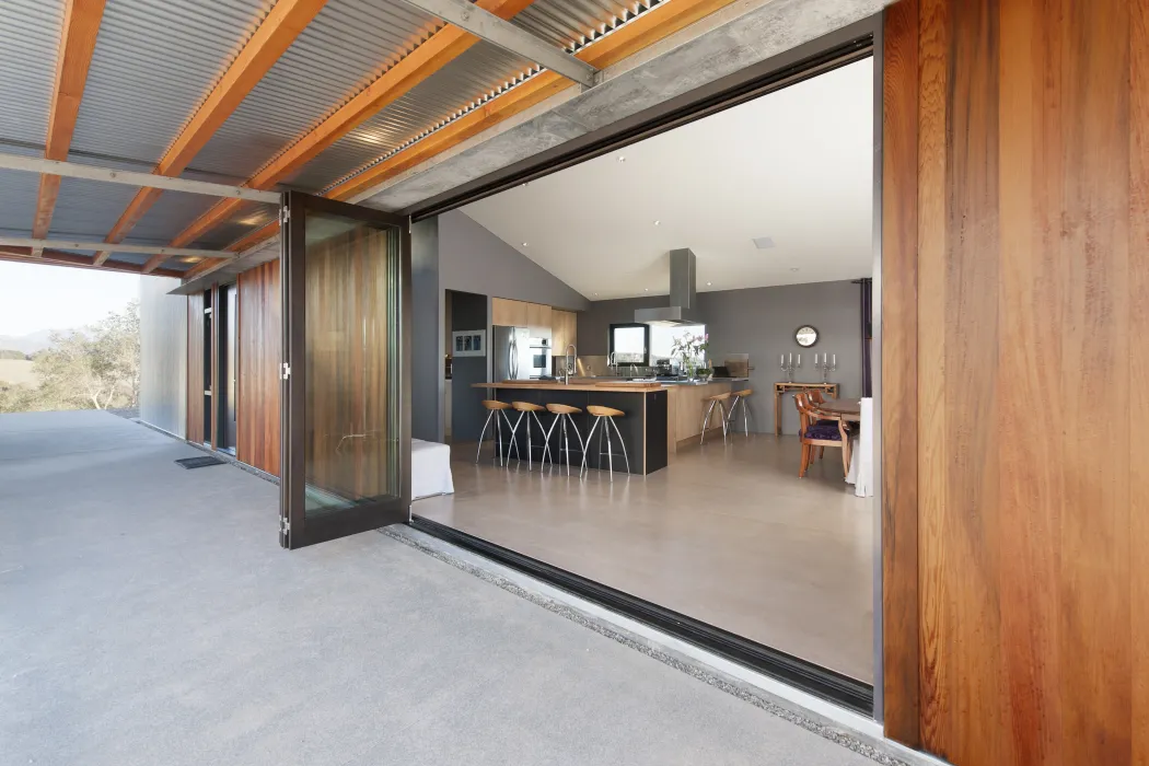 Looking into the kitchen at Healdsburg Rural House from the large open glass door in Healdsburg, California.