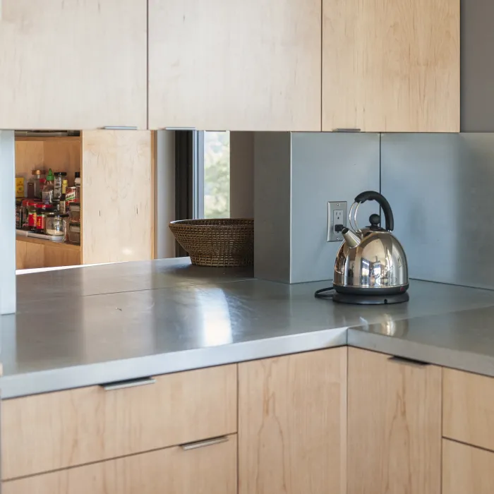 Kitchen detail of the wood cabinets with a peak into the pantry in the background at Healdsburg Rural House in Healdsburg, California.